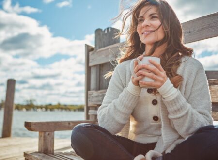 Confident woman smiling outdoors after a smile makeover, highlighting orthodontic treatments for adults and family orthodontic care benefits.