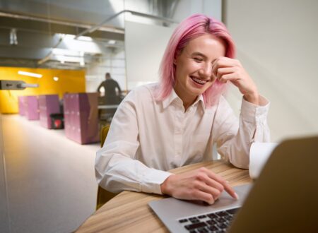Confident professional woman smiling at work while considering adult braces, orthodontics for adults, and straightening teeth without braces.