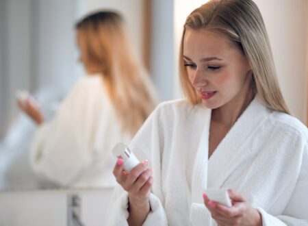 Skincare products featuring active skincare products, retinal night cream, and morning vitamin C serum arranged as part of a simple routine.