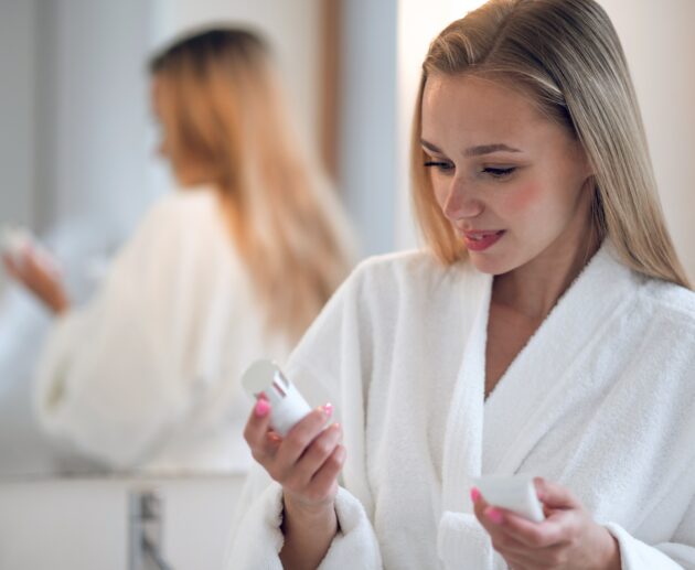 Skincare products featuring active skincare products, retinal night cream, and morning vitamin C serum arranged as part of a simple routine.