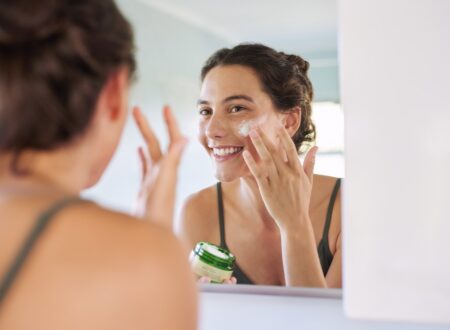 Woman applying an anti ageing serum after using a sensitive skin cleanser as part of a simple active skincare routine.