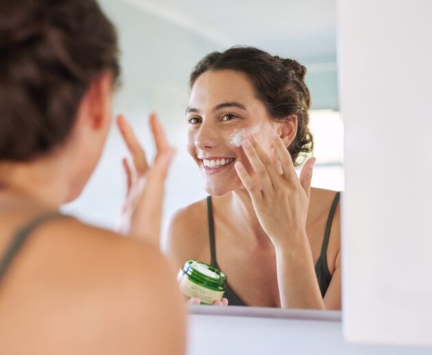 Woman applying an anti ageing serum after using a sensitive skin cleanser as part of a simple active skincare routine.