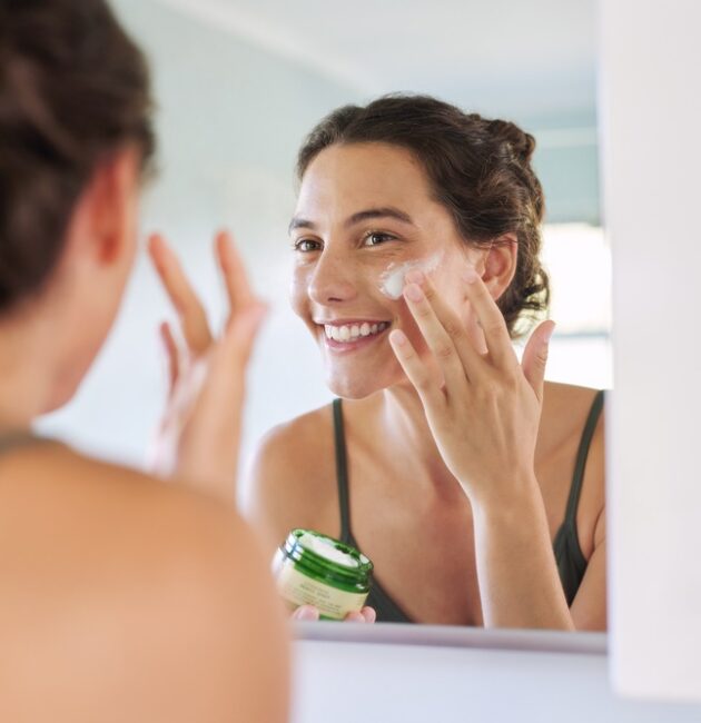 Woman applying an anti ageing serum after using a sensitive skin cleanser as part of a simple active skincare routine.
