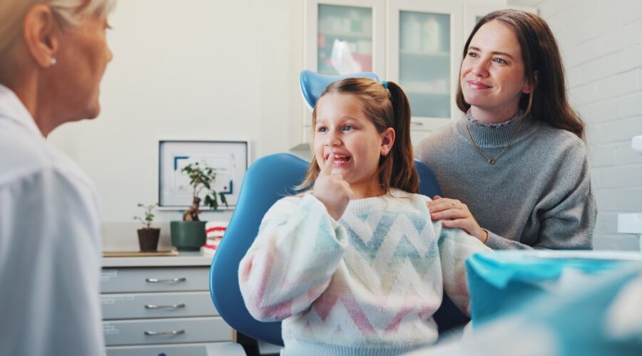 Parent speaking with a childrens orthodontist about family orthodontic care and early orthodontic treatment for their child.