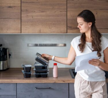 Woman looking at her order from one of the best healthy meal delivery services providers in Australia.