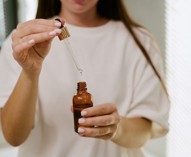 Woman comparing Australian skincare products, active skincare and the best skincare products in Australia to build a simple skincare routine.